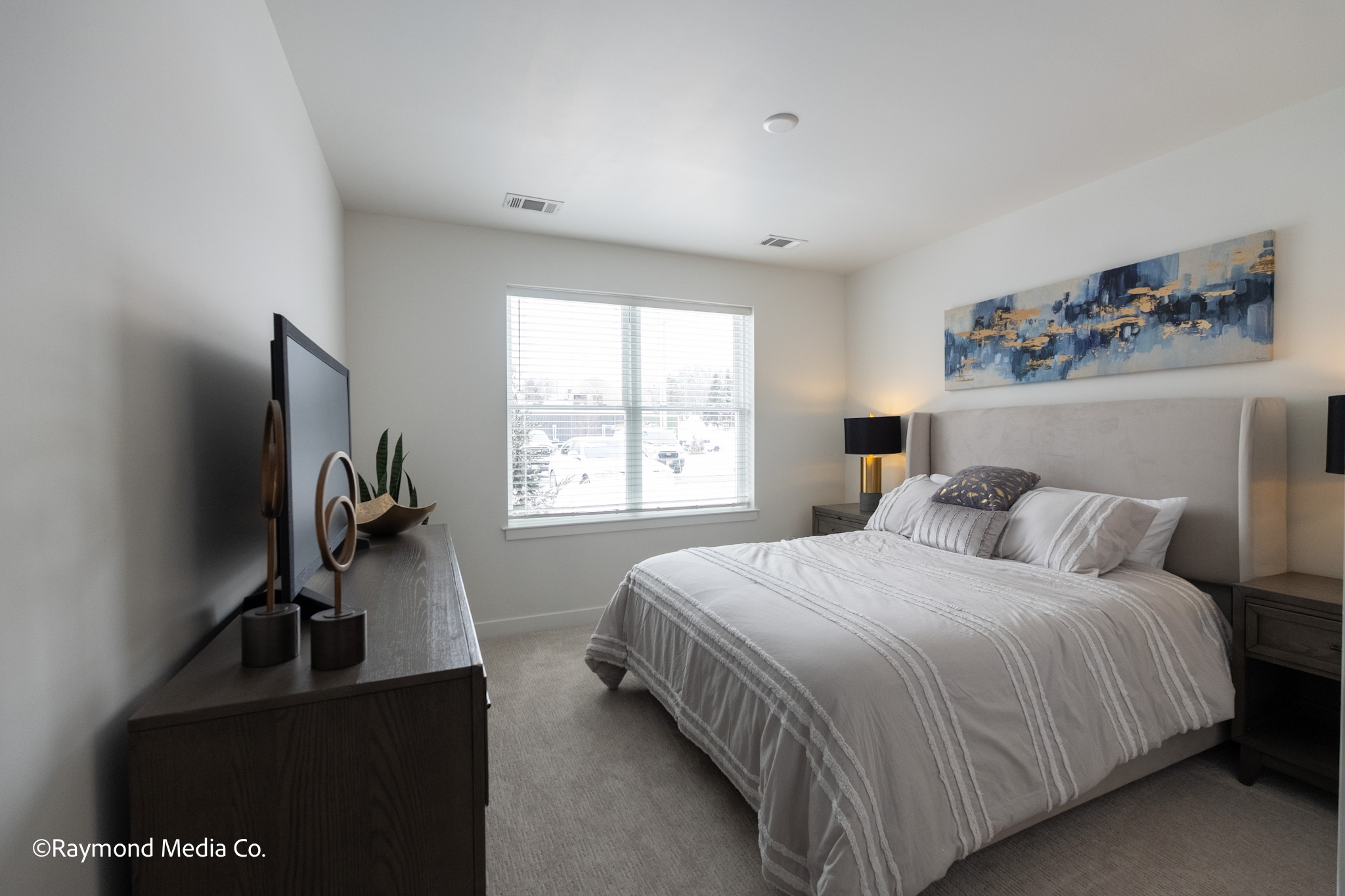 Modern apartment bedroom in Maine photographed from entry doorway